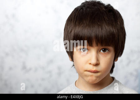 Riflessivo bit boy il suo labbro Foto Stock