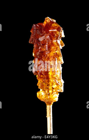 Caramelle di zucchero di canna su un bastone Foto Stock