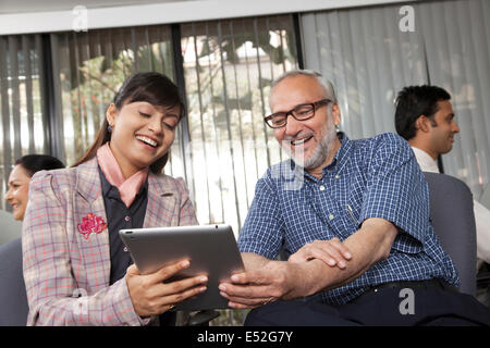 Senior l uomo e la donna che guarda un tablet Foto Stock