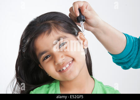 Ritratto di bambina ottenere gocce mettere in ear Foto Stock