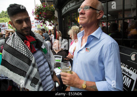 Londra, Regno Unito. Sabato 19 Luglio 2014. Pro-Palestinian manifestanti nella loro decine di migliaia di marzo attraverso il centro di Londra all'Ambasciata di Israele in segno di protesta contro l'offensiva militare a Gaza da parte di Israele. Manifestante britannico ha una pinta al di fuori di un pub come manifestanti pass. Credito: Michael Kemp/Alamy Live News Foto Stock