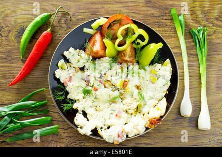 La frittata, uova strapazzate con verdure cipolle peperoni e pomodori Foto Stock