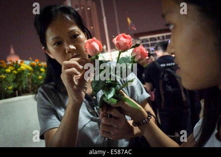 Kuala Lumpur, 22 luglio, 2014. Gli amici di MH17 Membri di equipaggio scegli un fiore le candele durante una vigilia di Kuala Lumpur in Malesia. Malaysia Airlines MH17 era in viaggio da Amsterdam a Kuala Lumpur quando si è schiantato uccidendo tutti 298 sul bordo di cui 80 bambini. Il velivolo è stato presumibilmente abbattuto da un missile e continuano le indagini sugli autori dell'attacco. Credito: Khairil Safwan/Pacific Press/Alamy Live News Foto Stock