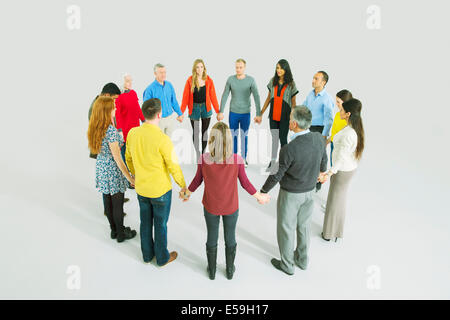 La gente di affari tenendo le mani in cerchio Foto Stock