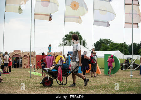 WOMAD festival di musica, Charlton Park, Regno Unito. Xxv Luglio, 2014. Blazing calore ed umidità pieno sul primo giorno del festival culmina in una flash terrential downpoor durante il tardo pomeriggio. Esso non ha messo i frequentatori del festival off e può solo bisogno di cercare una copertura per un breve periodo di tempo prima che il sole splendeva di nuovo. Più caldo è previsto nel corso del fine settimana. Foto Stock