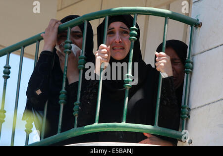 (140726) -- NABLUS, luglio 26, 2014 (Xinhua) -- i parenti dei due palestinesi, Tayyeb Shehada, 21 e Mohammed Odeh, 22, di cui i medici hanno detto sono stati uccisi durante gli scontri con le truppe israeliane venerdì, piangono durante il loro funerale in Cisgiordania città di Hawara vicino a Nablus, 26 luglio 2014. I medici hanno detto otto palestinesi sono stati uccisi in scontri nei pressi della Cisgiordania città di Nablus e Hebron venerdì dopo le proteste contro Israele dell operazione militare nella striscia di Gaza. (Xinhua/Ayman Nobani) Foto Stock