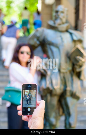 Un uomo di scattare una foto di una donna con un mobile smart phone Foto Stock
