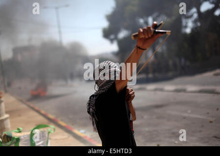 Betlemme. 1 agosto, 2014. Un palestinese protestor scontri con i soldati israeliani in Cisgiordania città di Betlemme il 1 agosto 2014 in segno di protesta contro i militari israeliani azione nella Striscia di Gaza. Il numero di morti nella Striscia di Gaza dal momento che una grande offensiva israeliana è iniziato il 8 luglio è salito a 1,428 Giovedì, con più di 8 mila feriti, a Gaza il Ministero della Sanità portavoce Ashraf al-Qedra detto. Credito: Xinhua/Alamy Live News Foto Stock