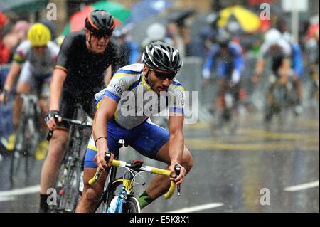 Gara di concorrenti in condizioni dure compresi heavy rain nella loro battaglia per una medaglia nel giorno finale sui giochi del Commonwealth a Glasgow Foto Stock