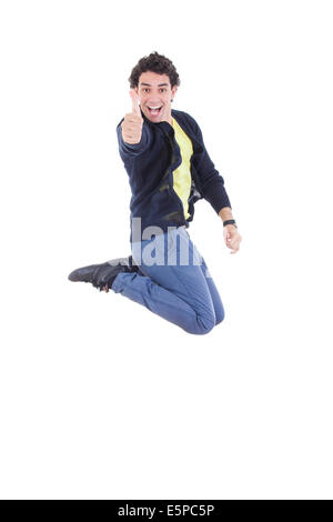 Ritratto di giovane felice espressivo uomo caucasico salti di gioia che mostra i pollici in su contro uno sfondo bianco Foto Stock