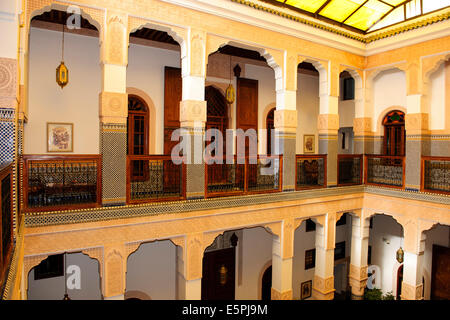 Riad Myra,bellissima scolpiti in stucco di pannelli di cedro,archi,pavimenti in pietra con intricati mosaici,Fontana centrale,tetto,Fez,Marocco Foto Stock