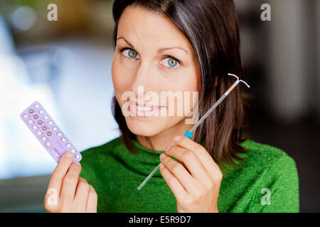 Donna che mantiene diversi contraccettivi. Foto Stock