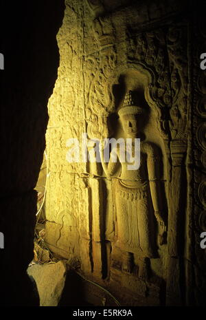 Il bassorilievo scultura di un devata Khmer (divinità femminile) in un angolo in rovina del tempio di Preah Khan, Angkor, Cambogia. Foto Stock