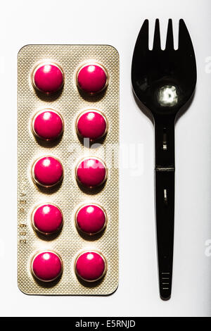 Pillole di rosa e la forcella. Foto Stock