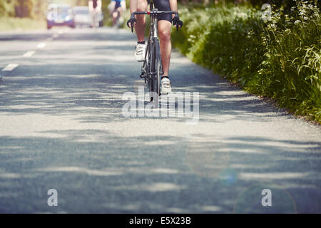 I ciclisti equitazione sulla strada a carreggiata singola, Cotswolds, REGNO UNITO Foto Stock