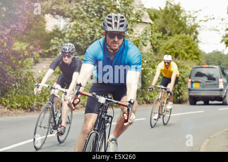 I ciclisti equitazione sulla strada a carreggiata singola, Cotswolds, REGNO UNITO Foto Stock