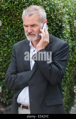 Londra, Regno Unito. Il 7 agosto, 2014. Membro conservatore del London Assembly, Andrew Boff parla al telefono come il sindaco Boris Johnson visite Rabbi Osher Schapiro e la comunità ebraica di Stamford Hill, Londra Credito: Piero Cruciatti/Alamy Live News Foto Stock