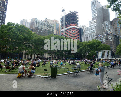 Gli ospiti siedono in Bryant Park di New York City, Stati Uniti d'America, 28 giugno 2014. Il parco è situato in posizione centrale a Manhattan. Il parco è un importante destinazione turistiche e popolare con i turisti e la gente del posto. Foto: Alexandra Schuler/dpa - ATTENZIONE! Nessun filo SERVICE - Foto Stock