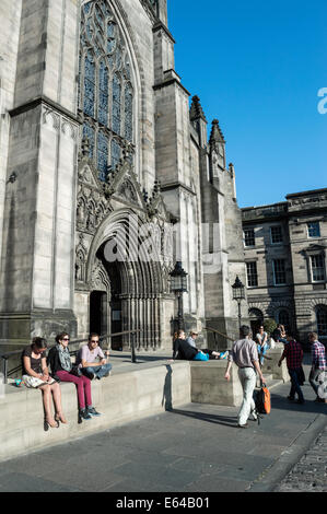 Turisti che si godono la serata sole estivo davanti alla Cattedrale di St Giles, Edimburgo Città Vecchia Foto Stock