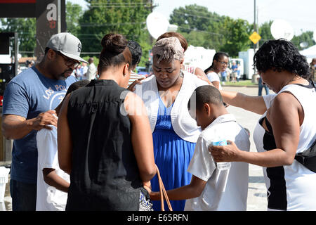 Ferguson, Mo., noi. Il 15 agosto, 2014. Il gruppo si riuniscono per pregare presso il sito del distrutto viaggio veloce dopo il capo di polizia Thomas Jackson rilascio del nome del funzionario che shot Michael Brown. Credito: Gino's immagini Premium/Alamy Live News Foto Stock