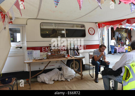 Seven Dials, Londra, Regno Unito. Il 16 agosto 2014. Un "Emergenza Poeta' fornisce prescrizioni. Il Seven Dials è priva di traffico e la copertura in erba artificiale come le persone godono di festival. Credito: Matteo Chattle/Alamy Live News Foto Stock