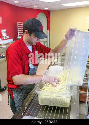 Titolare di una piccola azienda di Pizza Shop (pizzeria) ripieno di formaggio grattugiato bin, STATI UNITI D'AMERICA Foto Stock