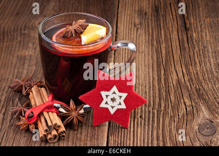 Vin brulé in un bicchiere sul vecchio sfondo di legno Foto Stock