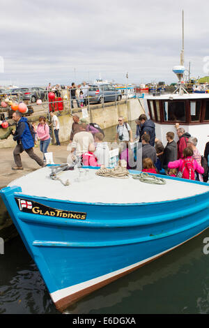 Il lieto annunzio giorno di viaggio barca restituiti dal farne isole, Seahouses harbor , Northumberland, con lo sbarco di passeggeri Foto Stock