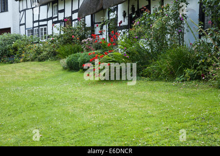 Con travi in legno e cottage con il tetto di paglia di corsia in barca nel grazioso villaggio di Welford-on-Avon, Warwickshire, Inghilterra. Foto Stock