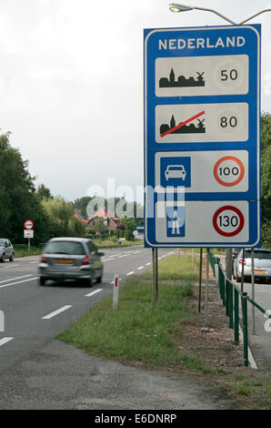 Un limite di velocità su strada sul segno della frontiera tra i Paesi Bassi (Nederland) e Belgio (Belgique). Foto Stock
