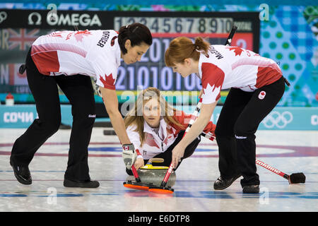 Jennifer Jones (C) pone una pietra con Jill Officer (L) e Dawn McEwen della medaglia d oro vincere in Canada nel corso di spazzamento per donna Foto Stock