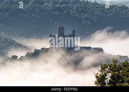 Come dawn si rompe e il sole sorge, la nebbia attorno al castello Najac brucia progressivamente off. Foto Stock