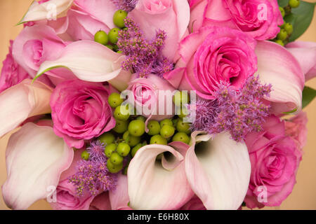 Un mazzo di fiori in bellissimi colori rosa - rose e calla lillies. Foto Stock