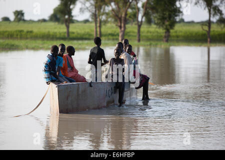 I bambini utilizzano barca donati da ACAD per attraversare il fiume a Achok Agok, provincia di Abyei, Sudan / Sud Sudan. Foto Stock