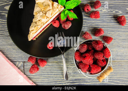 Lampone torta con meringa top disposti su una tavola di legno Foto Stock