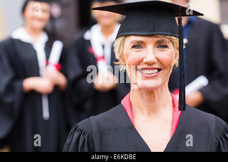 Grazioso centro di età professore universitario presso gli studenti cerimonia di consegna dei diplomi Foto Stock
