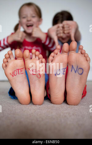 Rosso 'votare sì' e blu 'votare no' scritto su bambini in piedi un tempo vicino alla scozzese referendum di indipendenza del 2014. Foto Stock