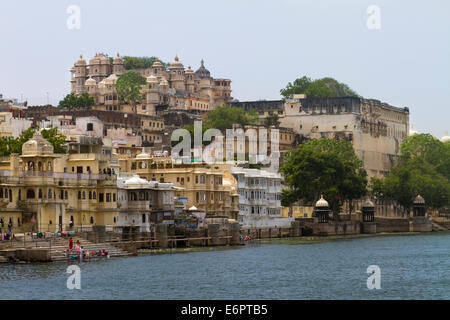 Vista del Palazzo di città ed edifici sulle rive del lago Pichola in Udaipur, Rajastan Foto Stock