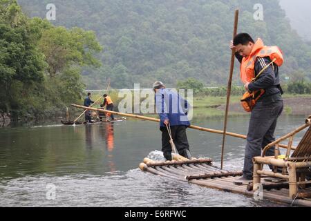 I pescatori locali portano i turisti su una zattera di bamboo crociera lungo il fiume Yulong in Cina Foto Stock