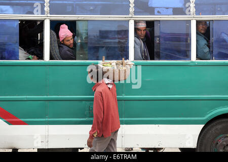 Venditore ambulante che vende spuntini per i passeggeri di autobus locali a Damak, Nepal Foto Stock