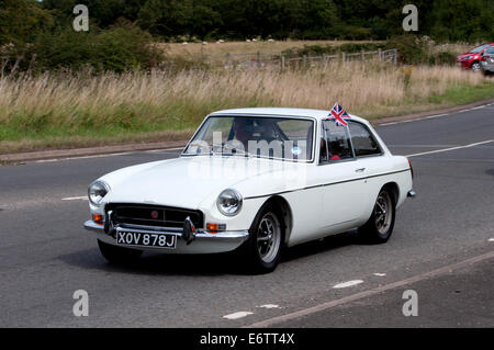 MGB GT auto su Fosse Way road, Warwickshire, Regno Unito Foto Stock