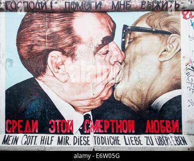 Berlino - 24 agosto 2014 : La East Side Gallery è la più grande galleria d'arte a cielo aperto in tutto il mondo. Questo pezzo di muro mostra un graffiti del bacio fraterno di ex politici Breschnew Honecker e. Foto Stock