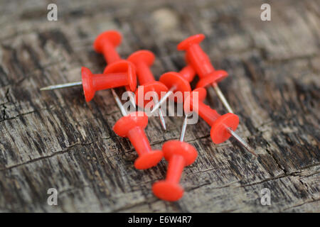 Set di vecchi perni di rosso su uno sfondo di legno Foto Stock