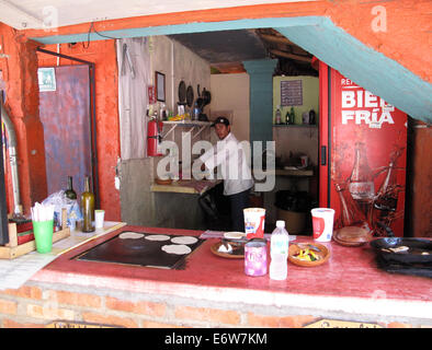 L'uomo la preparazione di cibo in un taco stand in Sayulita, Messico. Foto Stock
