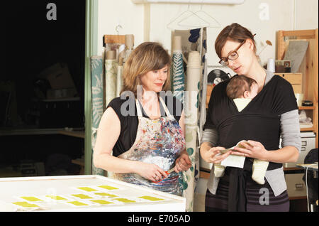 Le donne a discutere di design in mano-stampa workshop tessile Foto Stock