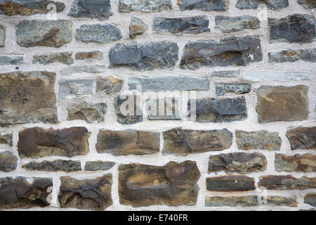 Il vecchio muro di pietra sullo sfondo Foto Stock