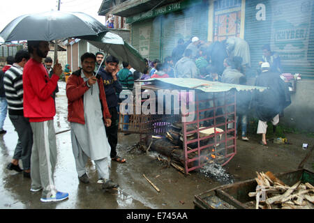 Srinagar, Indiano Kashmir amministrato6th sett, 2014: persone distribuire riso speciale fra i bisognosi in modo tale da cercare di aiutare da allah e ci sia un termine per la pioggia continua Jammu e Kashmir preaperd al casello di 100 nelle peggiori inondazioni nello stato in quasi sei decenni. Sette persone sono morte in due diversi incidenti di una casa di collassare a causa di frana provocata dalle forti piogge nel distretto di Udhampur e altri quattro corpi sono stati ritrovati nel distretto di Rajouri, un membro ufficiale del governo detto.(Sofi Suhail/Alamy Live News ) Foto Stock