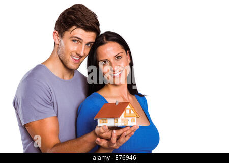 Coppia giovane tenendo un modello di casa Foto Stock