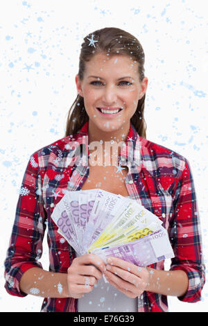 Immagine composita del ritratto di una donna azienda banconote Foto Stock