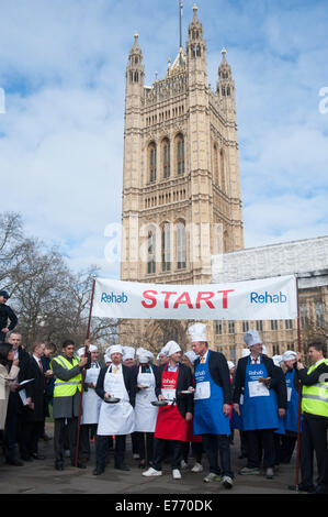 I giornalisti e i parlamentari di competere per carità al parlamentare annuale Pancake Race svoltosi a torre di Victoria Gardens a Londra centrale. Dotato di: atmosfera dove: Londra, Regno Unito quando: 04 Mar 2014 Foto Stock